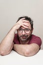 Portrait of a smiling mature man with beard wearing red t-shirt and glasses Royalty Free Stock Photo