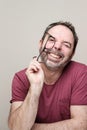 Portrait of a smiling mature man with beard wearing red t-shirt and glasses Royalty Free Stock Photo