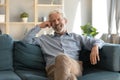 Portrait smiling mature man sitting on couch at home Royalty Free Stock Photo