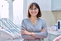 Portrait of smiling mature woman in dental clinic looking at camera Royalty Free Stock Photo