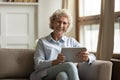 Portrait of smiling mature woman using modern tablet Royalty Free Stock Photo