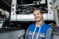 Portrait smiling mechanic adjusting tire