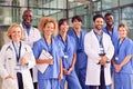 Portrait Of Smiling Medical Team Standing In Modern Hospital Building Royalty Free Stock Photo