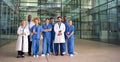 Portrait Of Smiling Medical Team Standing In Modern Hospital Building