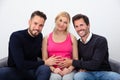 Smiling Men Touching The Belly Of Pregnant Surrogate Woman