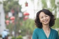 Portrait of Smiling Mid Adult Woman in Nanluoguxiang, Beijing, China