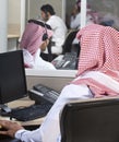 Portrait of a smiling Middle eastern employee with headphones on