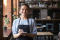Portrait of smiling waitress in apron looking at camera Royalty Free Stock Photo