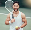 Portrait of smiling mixed race tennis player holding racket and ball on court. Happy fit confident hispanic professional Royalty Free Stock Photo