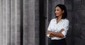 Portrait of a Smiling Mixed Races Business Woman, Crossed Arm and Looking away in the City Royalty Free Stock Photo