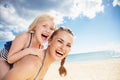 Smiling modern mother and daughter in beachwear on seashore Royalty Free Stock Photo