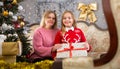 Portrait of smiling mom with little daughter during christmas celebration Royalty Free Stock Photo