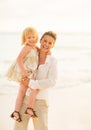 Portrait of smiling mother and baby girl on beach Royalty Free Stock Photo