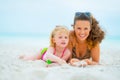 Portrait of smiling mother and baby girl on beach Royalty Free Stock Photo