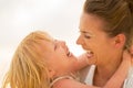 Portrait of smiling mother and baby girl hugging Royalty Free Stock Photo