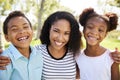 Portrait Of Smiling Mother With Children Relaxing In Park Royalty Free Stock Photo