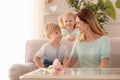 Portrait of smiling mother and her cute little children at home Royalty Free Stock Photo