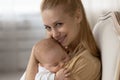 Portrait of smiling mother lull baby infant