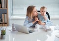 Cheerful mom speaking with baby in office