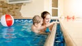 Portrait of happy smiling mother with 3 years old little son swimming in the pool at gym. Family raelaxing, having fun Royalty Free Stock Photo