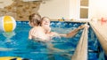 Portrait of happy smiling mother with 3 years old little son swimming in the pool at gym. Family raelaxing, having fun Royalty Free Stock Photo