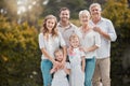 Portrait of a smiling multi generation caucasian family standing close together in the garden at home. Happy adorable Royalty Free Stock Photo