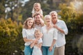 Portrait of a smiling multi generation caucasian family standing close together in the garden at home. Happy adorable Royalty Free Stock Photo