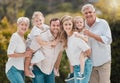 Portrait of a smiling multi generation caucasian family standing close together in the garden at home. Happy adorable Royalty Free Stock Photo