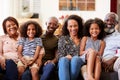 Portrait Of Smiling Multi-Generation Family Sitting On Sofa At Home Relaxing Together Royalty Free Stock Photo