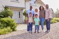 Portrait Of Smiling Multi-Generation Family Standing Outside Home Together Royalty Free Stock Photo