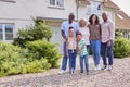 Portrait Of Smiling Multi-Generation Family Standing Outside Home Together Royalty Free Stock Photo