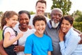 Portrait Of Smiling Multi-Generation Mixed Race Family In Garden At Home Royalty Free Stock Photo