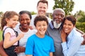 Portrait Of Smiling Multi-Generation Mixed Race Family In Garden At Home