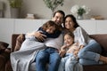 Portrait of smiling multiethnic family with kids relax at home
