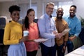 Portrait of smiling multiracial business advisors with document and tablet pc at modern office