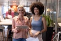 Portrait of smiling multiracial businesswomen working together at modern workplace