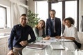 Portrait of smiling multiracial colleagues posing in office boardroom Royalty Free Stock Photo