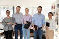 Portrait of smiling multiracial employees posing in office together Royalty Free Stock Photo