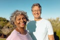 Portrait of smiling multiracial senior male and female friends standing against clear sky in yard Royalty Free Stock Photo