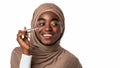 Portrait of smiling muslim black woman using serum Royalty Free Stock Photo