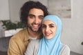 portrait of smiling muslim couple looking at camera