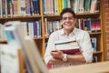 Portrait of smiling nerd holding books Royalty Free Stock Photo