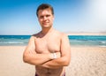 Portrait of smiling obese man with excess weight posing on the sea beach and looking in camera Royalty Free Stock Photo