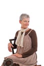 Portrait of smiling older woman sitting sideways Royalty Free Stock Photo