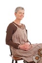 Portrait of smiling older woman sitting sideways Royalty Free Stock Photo