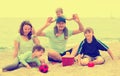 Portrait of smiling parents and their children on sand Royalty Free Stock Photo