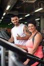 Smiling personal coach and female client in gym Royalty Free Stock Photo