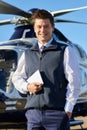 Portrait Of Smiling Pilot Standing In Front Of Helicopter With D Royalty Free Stock Photo