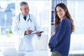 Portrait of smiling pregnant woman with male doctor in clinic Royalty Free Stock Photo