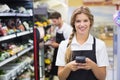 Portrait of smiling pretty blonde woman using handheld Royalty Free Stock Photo